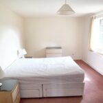 Furnished bedroom with double bed, bedside tables and dresser in Milton Keynes rental property