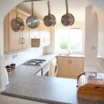Kitchen with white goods and window to dining area in flat to rent near Milton Keynes